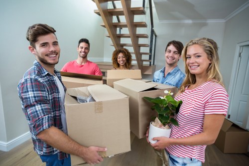 House removals in Docklands with moving van near modern apartments
